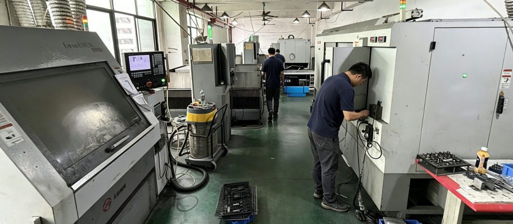 CNC fixture manufacturing workshop, factory workers processing test jigs and tooling fixtures on CNC machining centers