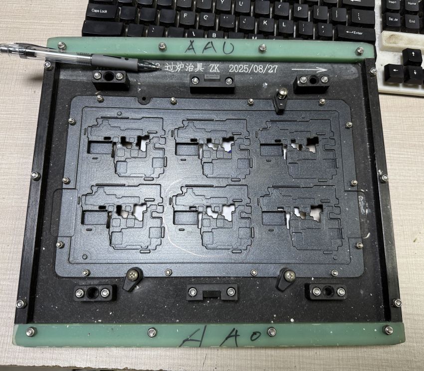 Top view of 6-up panel SMT wave soldering fixture with 6 PCB cavities, composite carrier plate and adjustable fasteners for SMT line