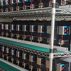 Close-up view of wiring and sockets on battery aging test rack fixture